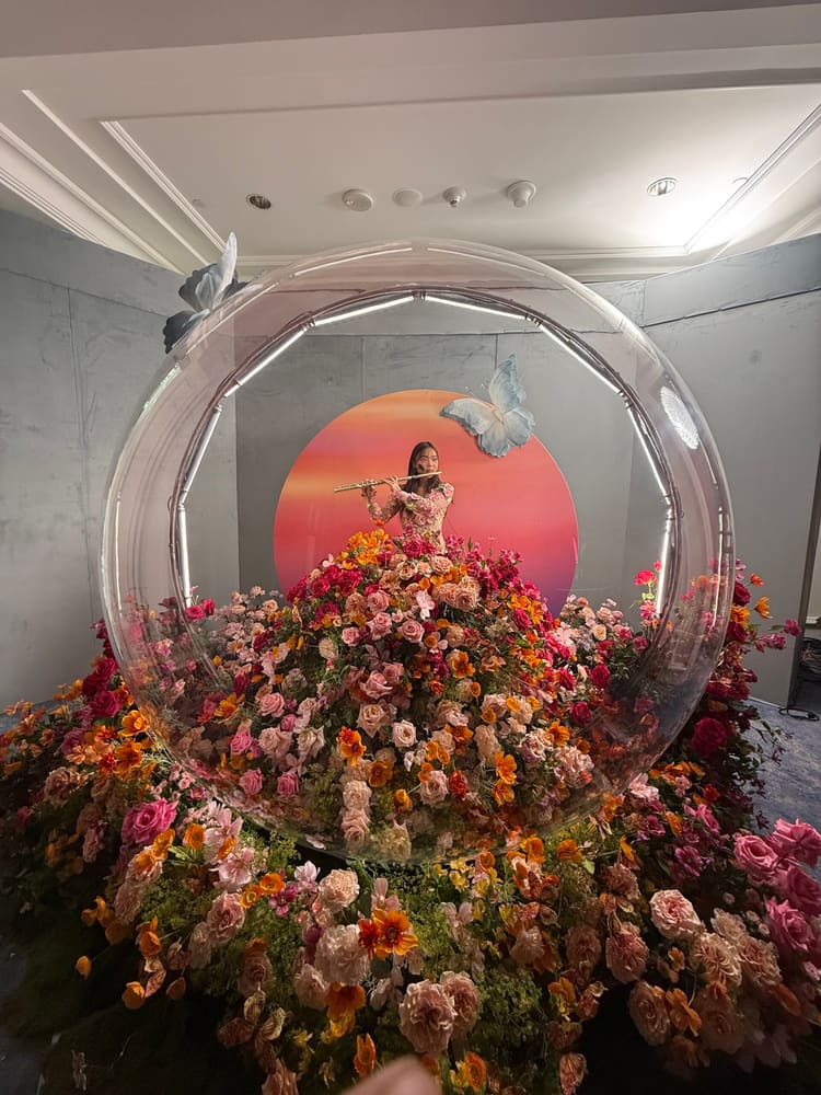 A floral installation around a glass sphere