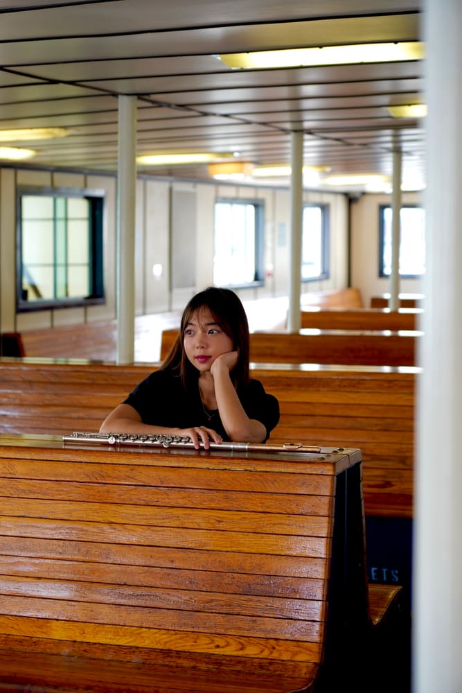 Monica sitting at a long wooden table